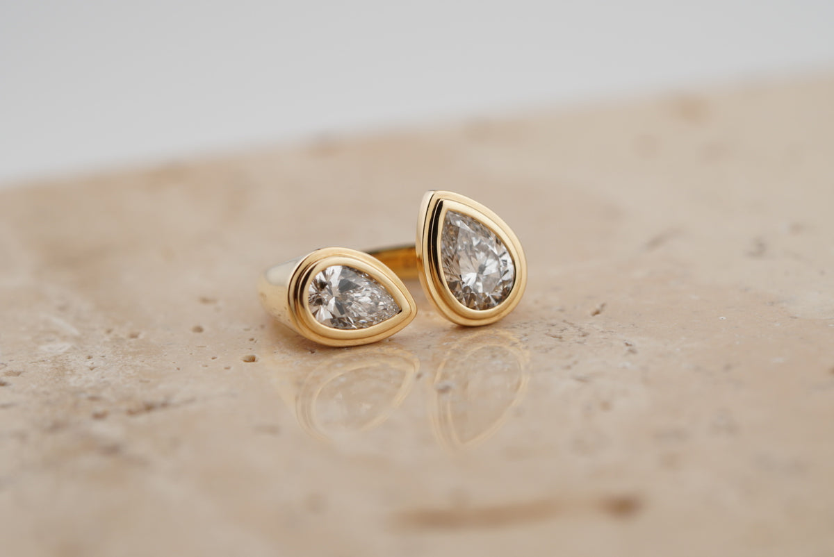 Nora Double Pear Ring on travertine, wider view